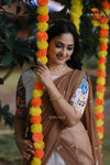 Woman in a saree with decorative flowers and 'Shivangi' branding