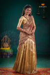 Woman in traditional gold and brown saree with 'Shivangi' branding in the background