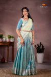 Woman in a traditional saree with a neutral background, featuring the brand 'Shivangi'.