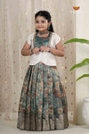 Young girl wearing a traditional outfit with a floral pattern against a neutral background